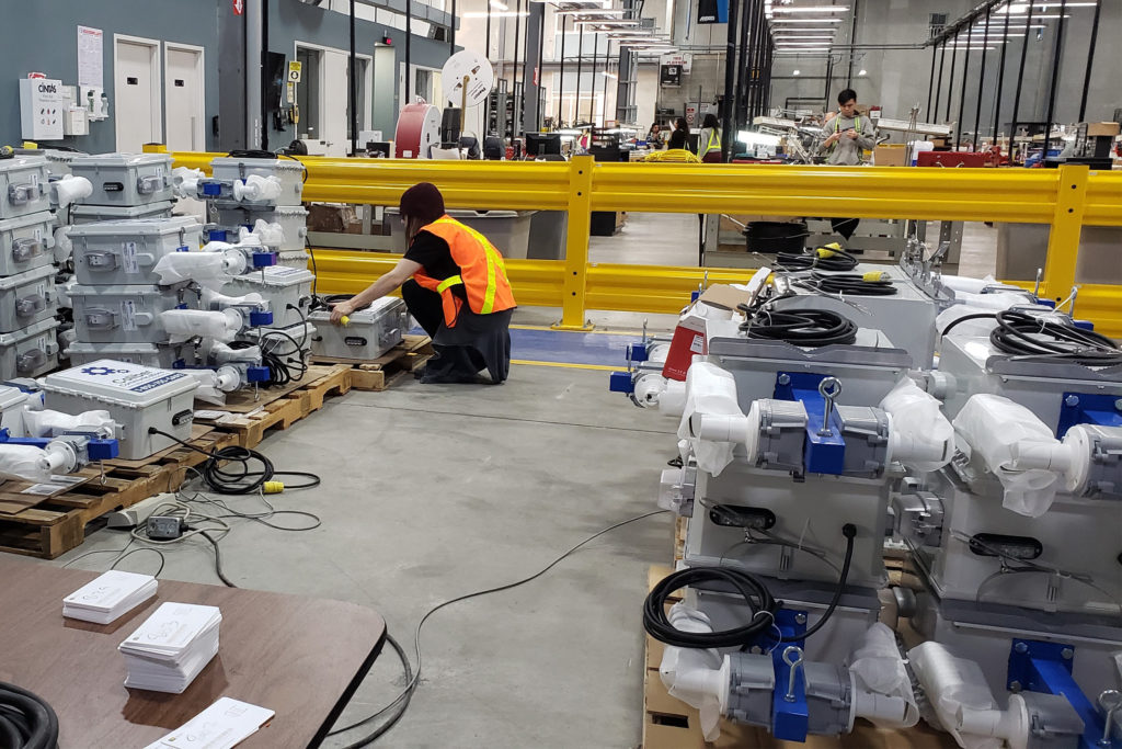 Caliber communications CSA inspected video monitoring units at warehouse with worker