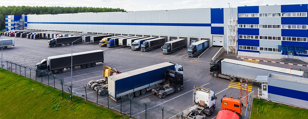 Transport trucks parked, loading and unloading at a distribution centre