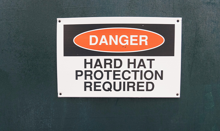 A sign that reads Danger: Hard Hat Protection Required