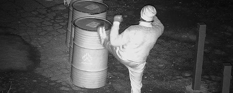 A suspect kicks over a can of flammable liquid