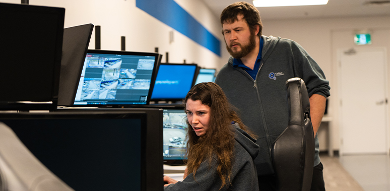 Caliber's Monitoring Operators watch over a bank of computer monitors