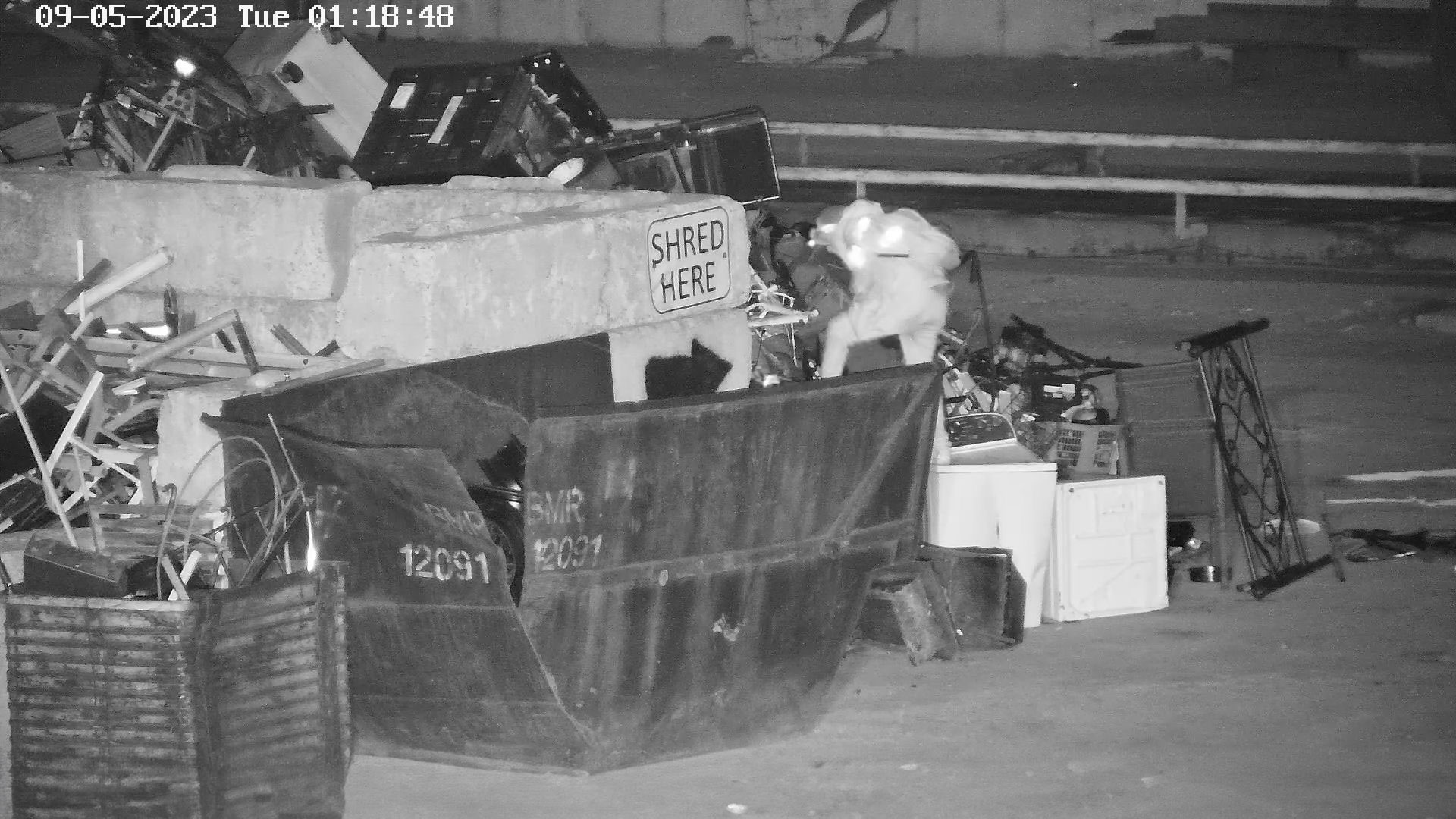 A suspect is caught on camera stealing from a recycling facility